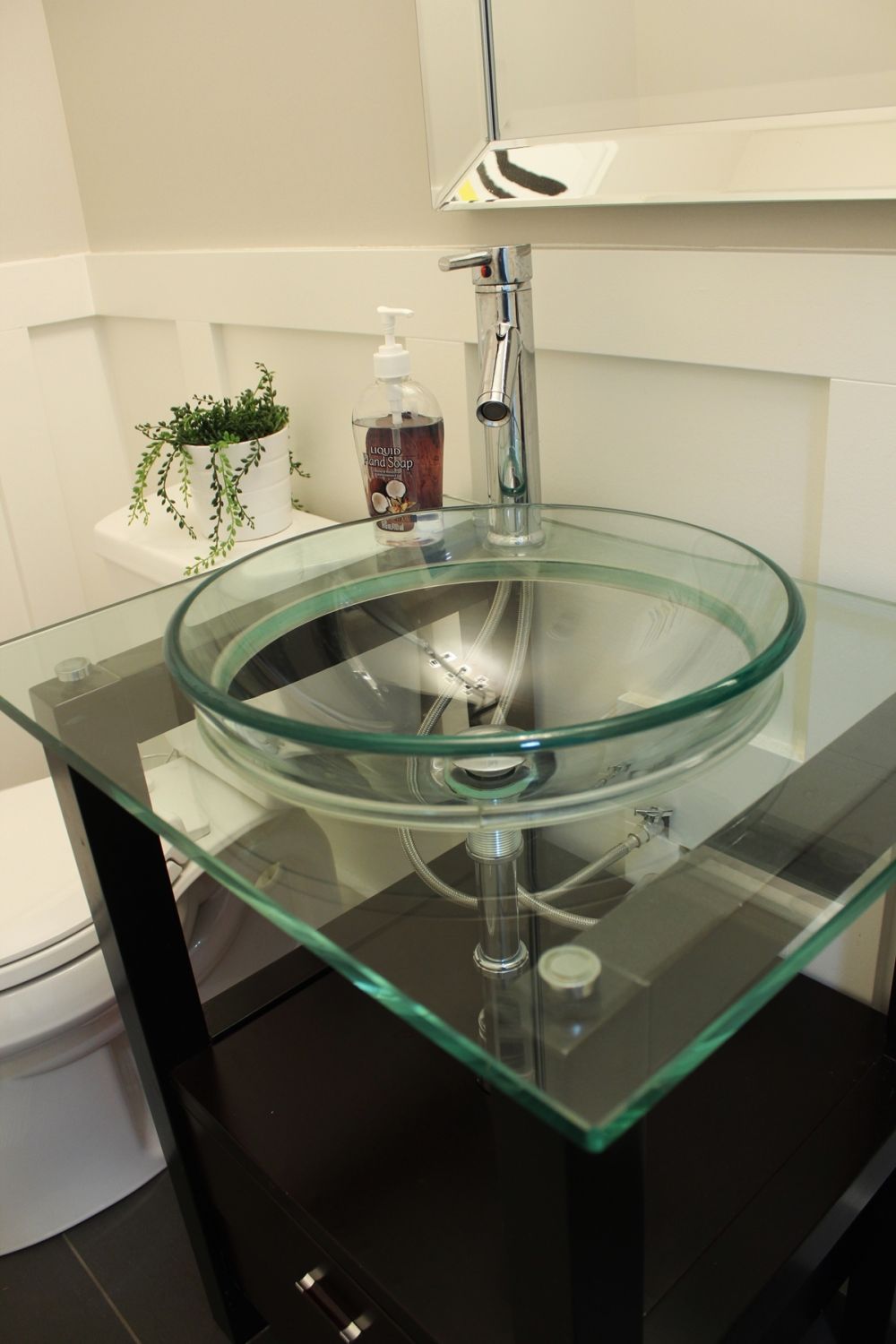 Bathroom with glass bowl sink.
